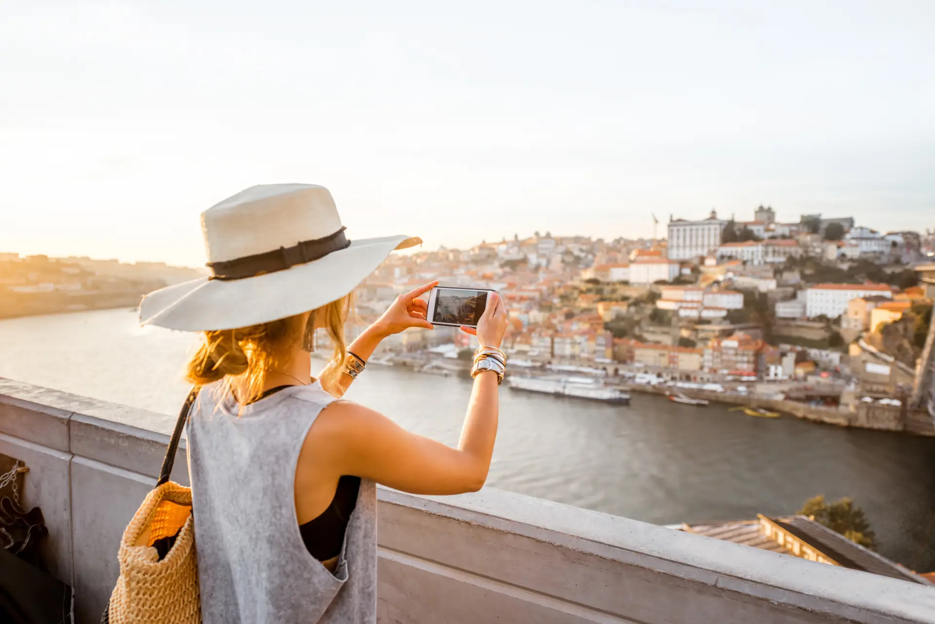 Woman tourist with camera phone in Porto