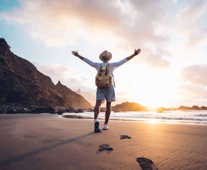 Happy traveller on beach