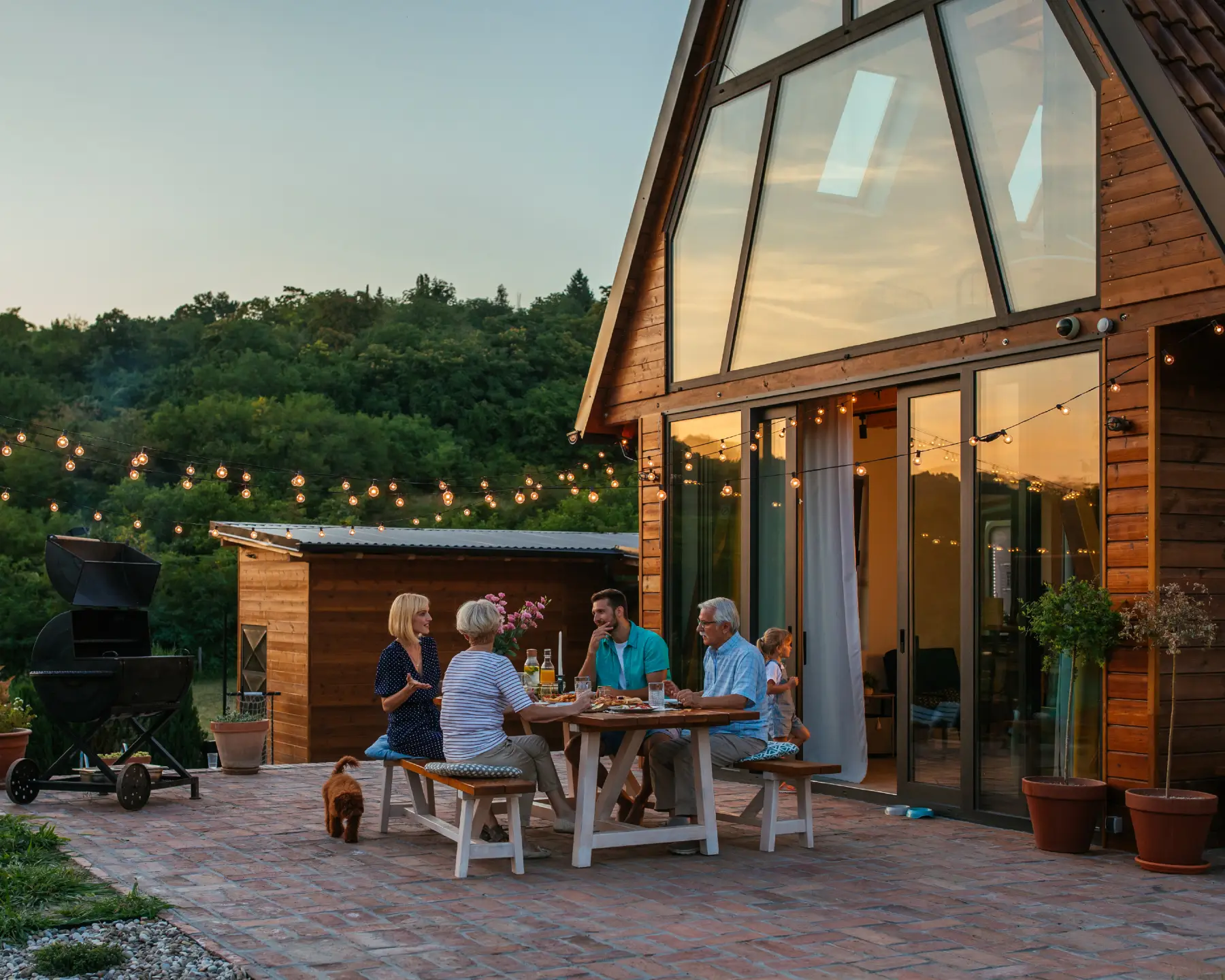 Home New 2 family gathering together on patio of holiday home